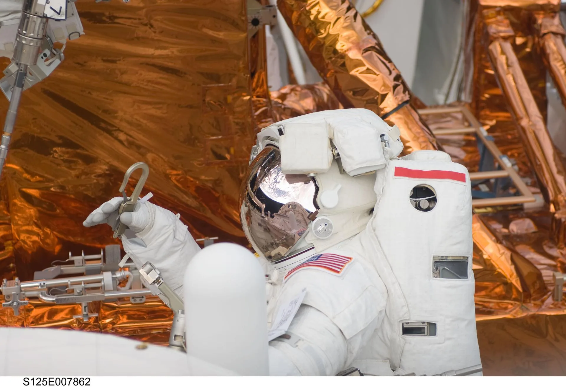 Astronot John Grunsfeld, 16 Mayıs 2009'daki STS-125 uzay yürüyüşünde Hubble Uzay Teleskobu üzerinde çalışmaya hazırlanıyor. Bu görevin görüntüleri Hubble 3D belgeselinde kullanıldı.
